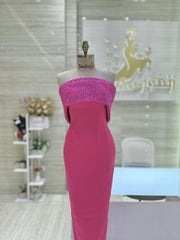 A soft peach, single-cloche dress with elegant sleeves, perfect for a family gathering.